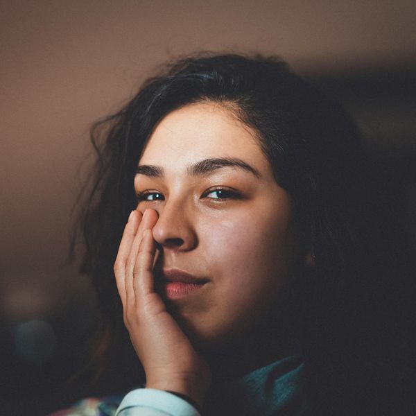 Person looking serene and energized after a workout session, with soft lighting.